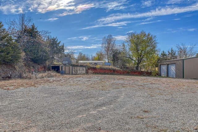 21351 E Tenth St, Hinton, OK 73047 - view of yard featuring an outdoor structure and a detached garage
