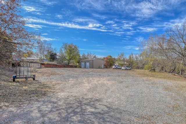 view of yard with a garage and an outdoor structure