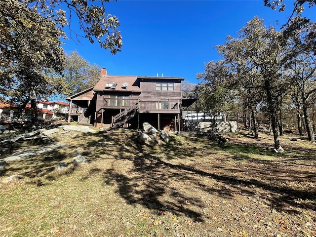 back of house with a wooden deck