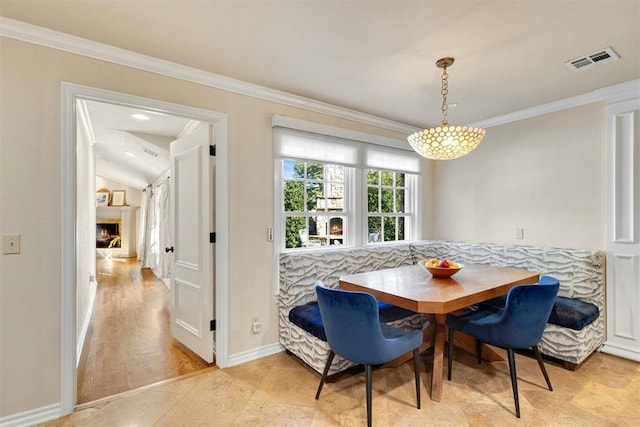 dining room with crown molding, breakfast area, a notable chandelier, and light hardwood / wood-style flooring