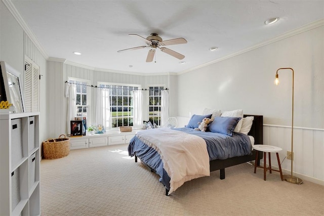 carpeted bedroom with ceiling fan and crown molding