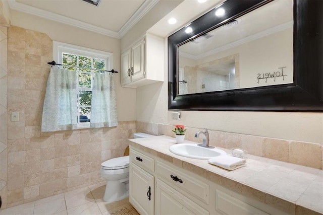 bathroom with vanity, toilet, ornamental molding, and tile walls