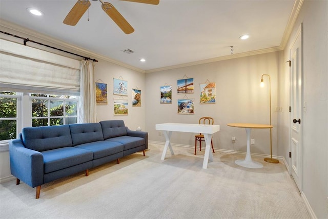 living room with ceiling fan, ornamental molding, and light carpet