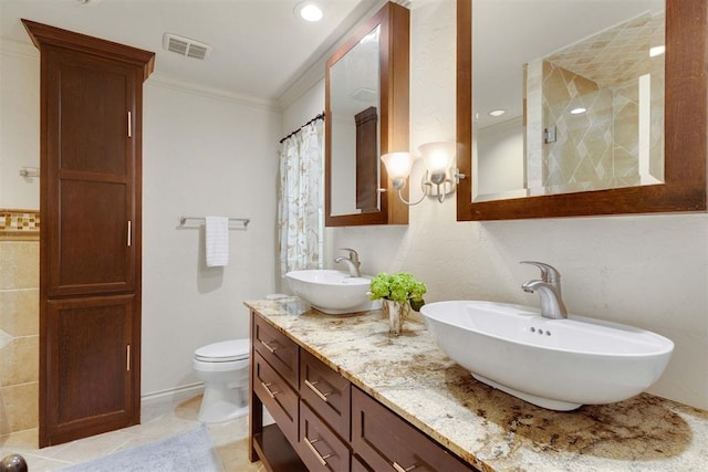 bathroom with vanity, tile patterned floors, crown molding, toilet, and walk in shower