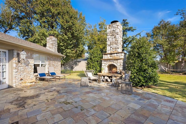 view of patio featuring an outdoor stone fireplace