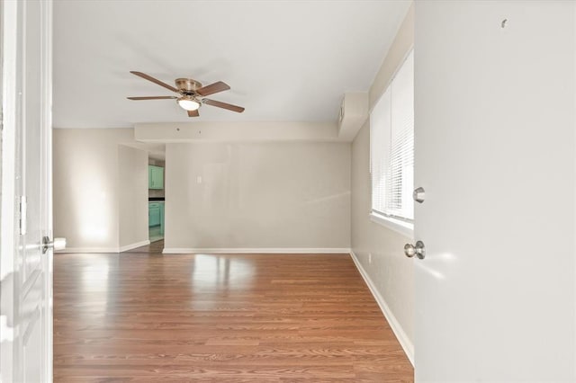 empty room featuring hardwood / wood-style floors and ceiling fan