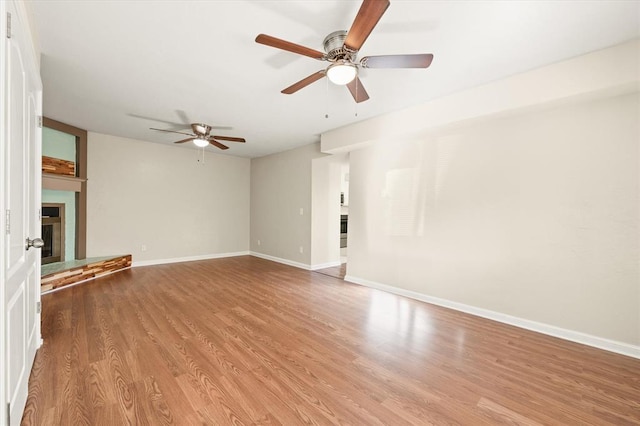 unfurnished living room with light hardwood / wood-style flooring and ceiling fan