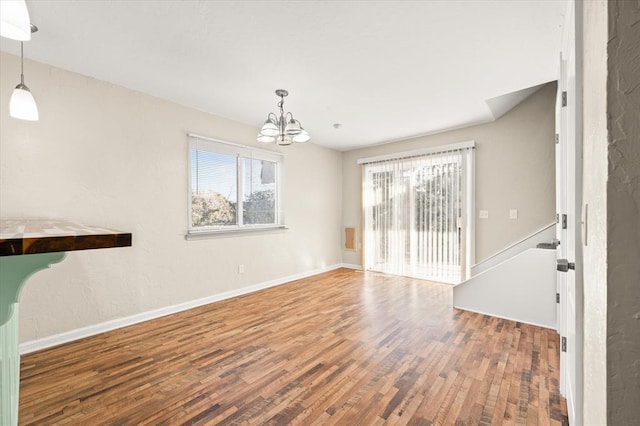 interior space featuring hardwood / wood-style floors and a notable chandelier