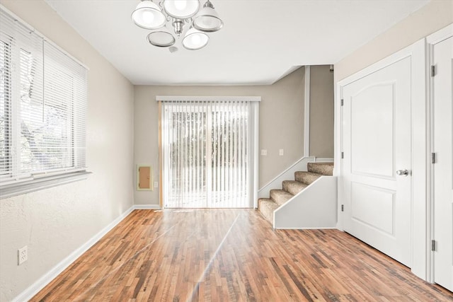 interior space featuring hardwood / wood-style floors and an inviting chandelier