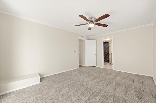 spare room featuring ceiling fan, crown molding, and light carpet