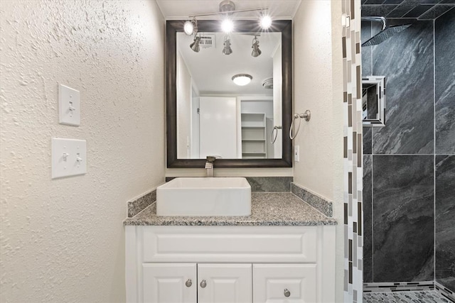 bathroom with a shower and vanity