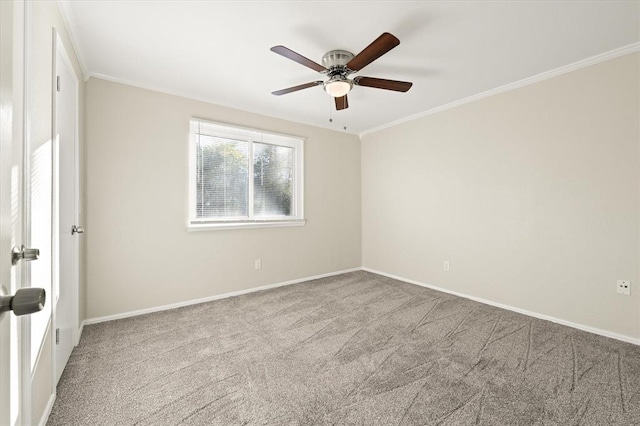 carpeted spare room featuring crown molding and ceiling fan