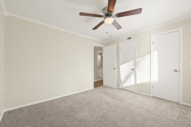 unfurnished bedroom with carpet, ceiling fan, and crown molding