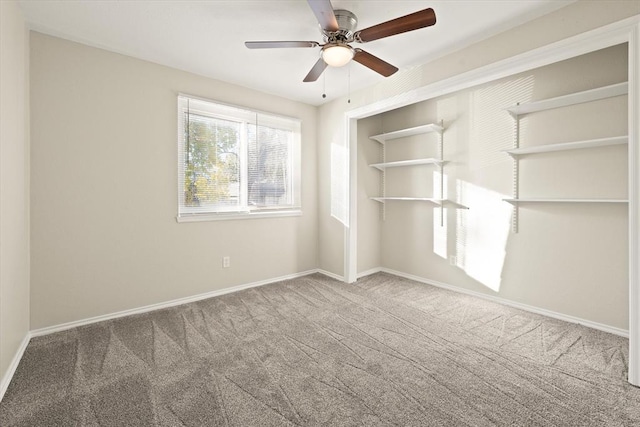 spare room featuring ceiling fan and carpet floors