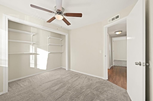 unfurnished bedroom featuring carpet, a closet, and ceiling fan