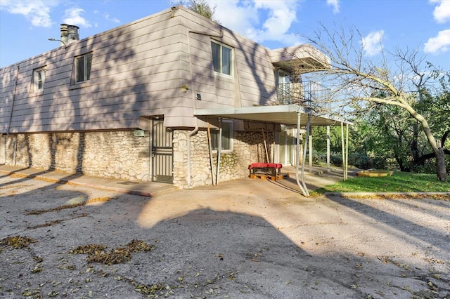 view of property exterior featuring a carport