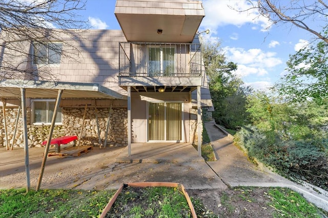 back of property with a balcony