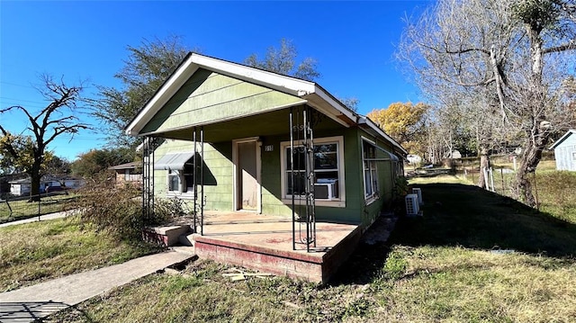 view of side of home with covered porch