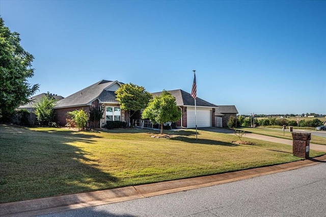 view of front of property featuring a garage and a front yard