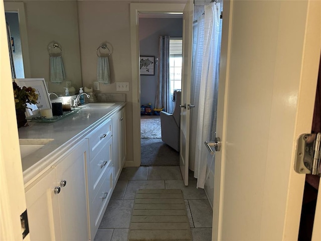 bathroom with tile patterned flooring, vanity, and toilet