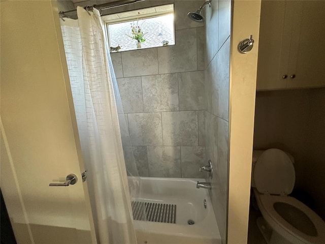 bathroom with shower / tub combo and toilet