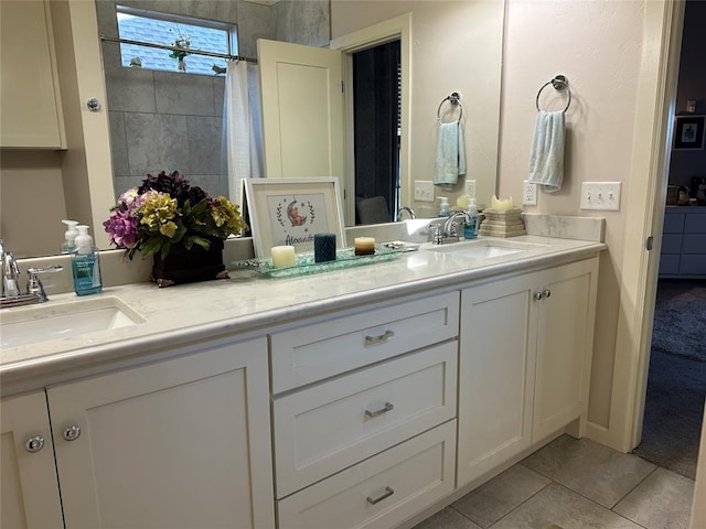 bathroom with tile patterned floors and vanity