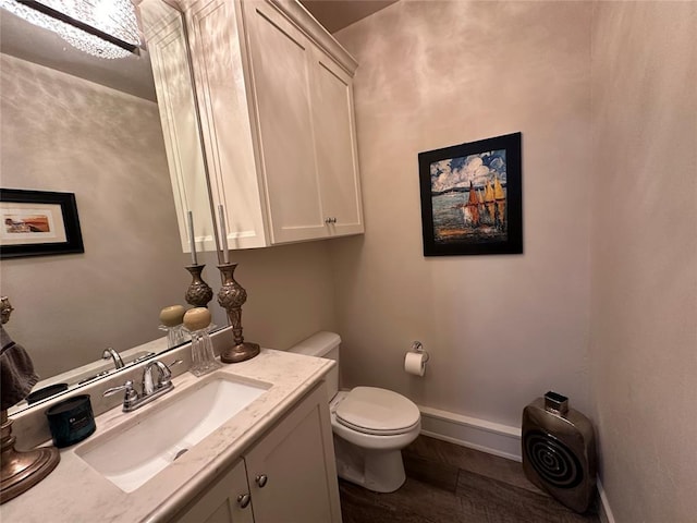 bathroom with vanity, hardwood / wood-style flooring, and toilet