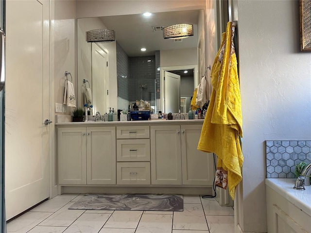 bathroom with vanity and tiled shower