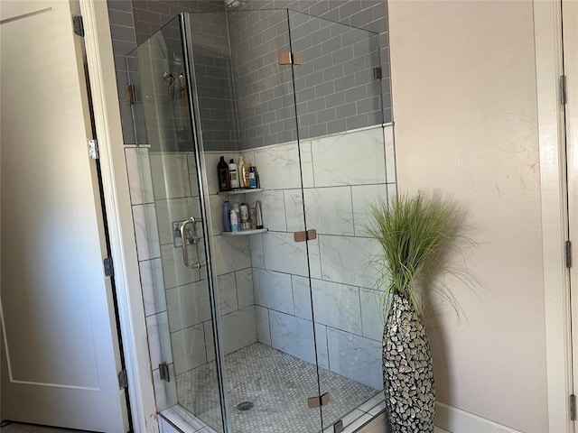 bathroom with a shower with shower door