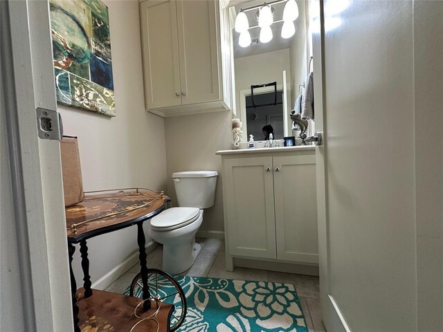 bathroom with tile patterned flooring, vanity, and toilet