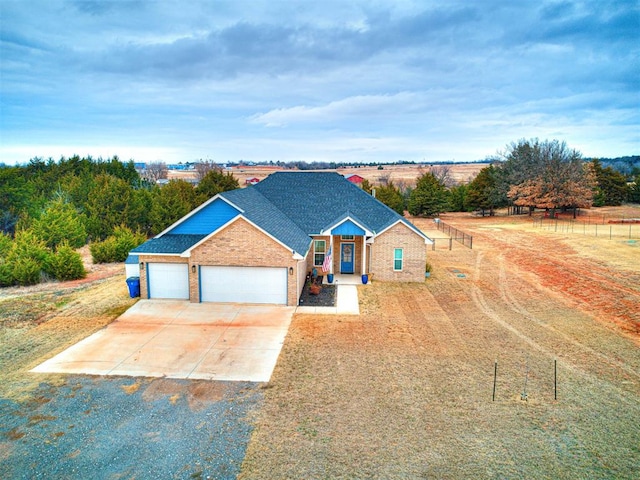 view of front of property with a rural view and a garage