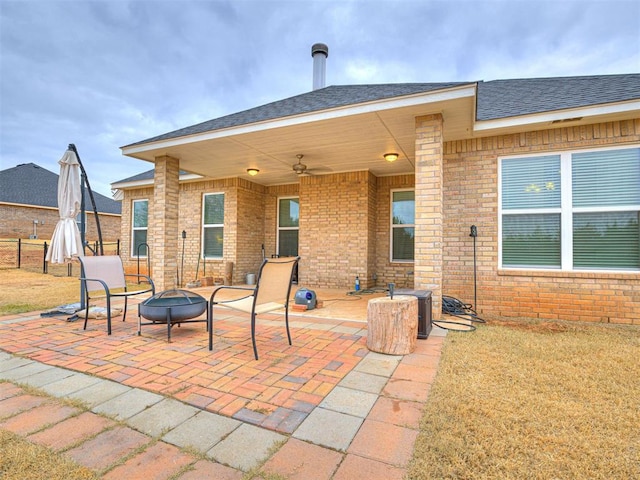 view of patio with ceiling fan and an outdoor fire pit