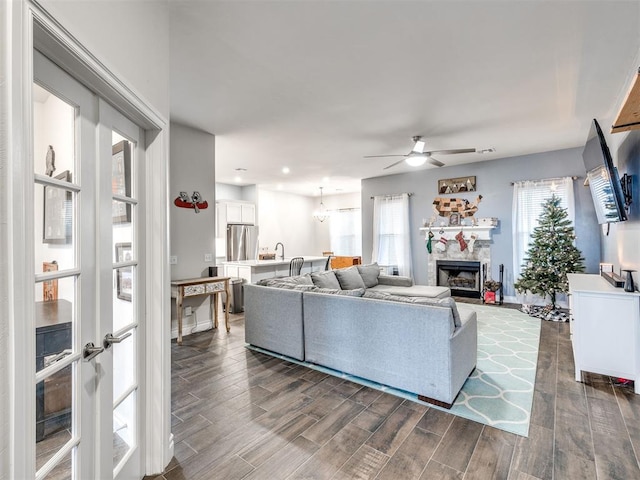 living room with ceiling fan and sink