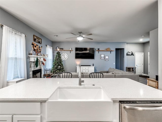 kitchen with ceiling fan, dishwasher, white cabinets, and sink