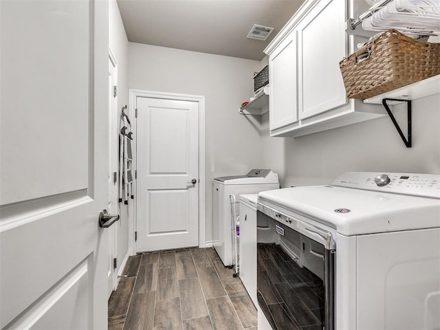 washroom with cabinets and independent washer and dryer