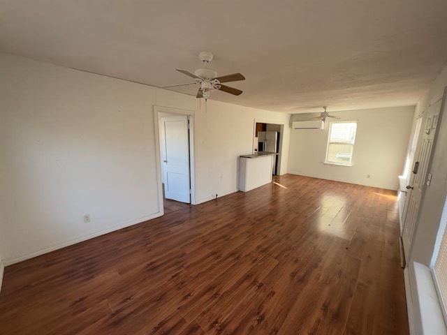 unfurnished living room featuring a wall mounted air conditioner, ceiling fan, and dark hardwood / wood-style flooring