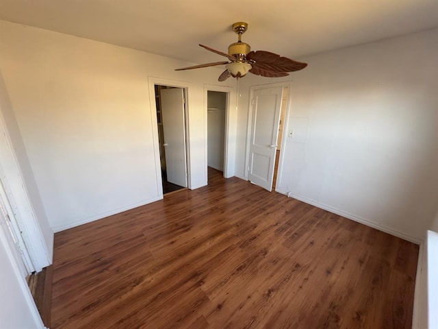 unfurnished bedroom featuring ceiling fan and dark hardwood / wood-style flooring