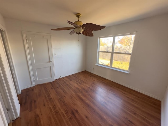 interior space featuring ceiling fan, dark wood-type flooring, and a closet