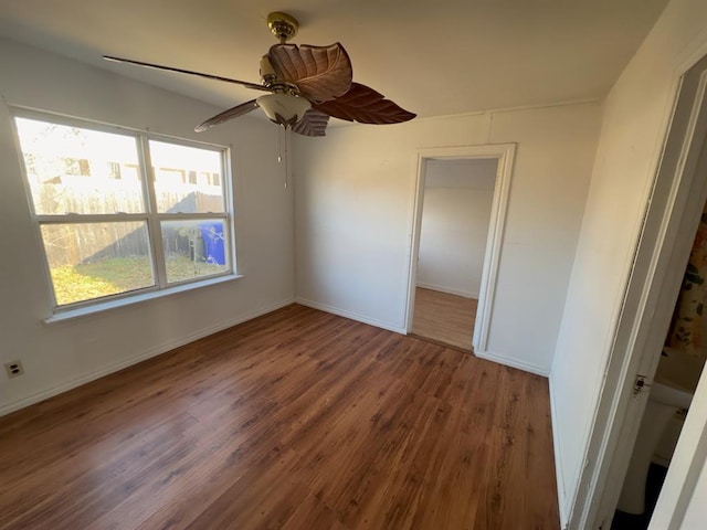 unfurnished bedroom with a closet, hardwood / wood-style flooring, and ceiling fan