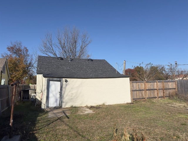 rear view of property featuring a yard and central AC