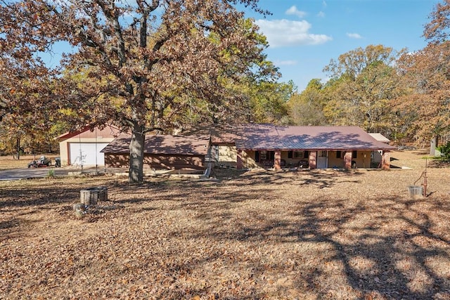 ranch-style house with covered porch and a garage