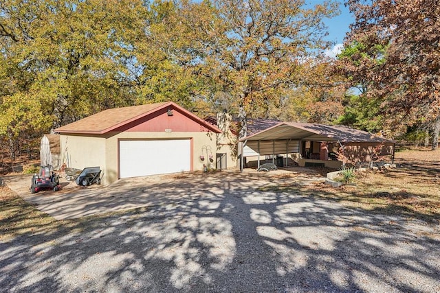 view of front of property with an outbuilding, a garage, and a carport