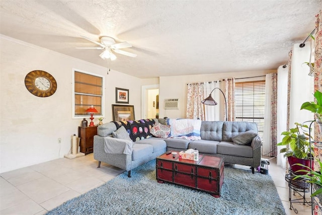 living room with ceiling fan, a wall mounted AC, a textured ceiling, light tile patterned flooring, and ornamental molding