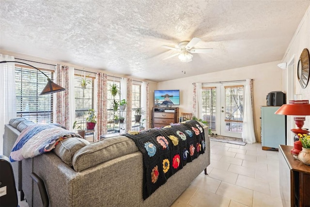 living room with french doors, a textured ceiling, lofted ceiling, and light tile patterned flooring