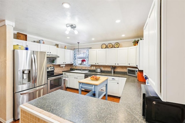 kitchen featuring white cabinets, hanging light fixtures, crown molding, sink, and appliances with stainless steel finishes