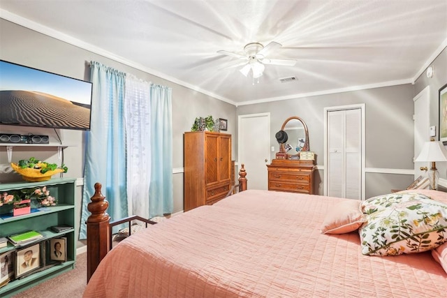 bedroom featuring carpet, ceiling fan, crown molding, and a closet