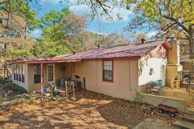 back of property featuring cooling unit