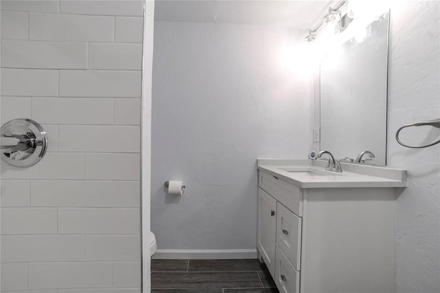 bathroom featuring hardwood / wood-style floors, vanity, and toilet