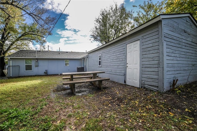 rear view of property with a yard