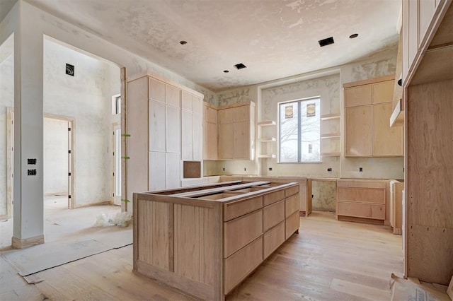 kitchen with light wood finished floors, open shelves, and light brown cabinetry